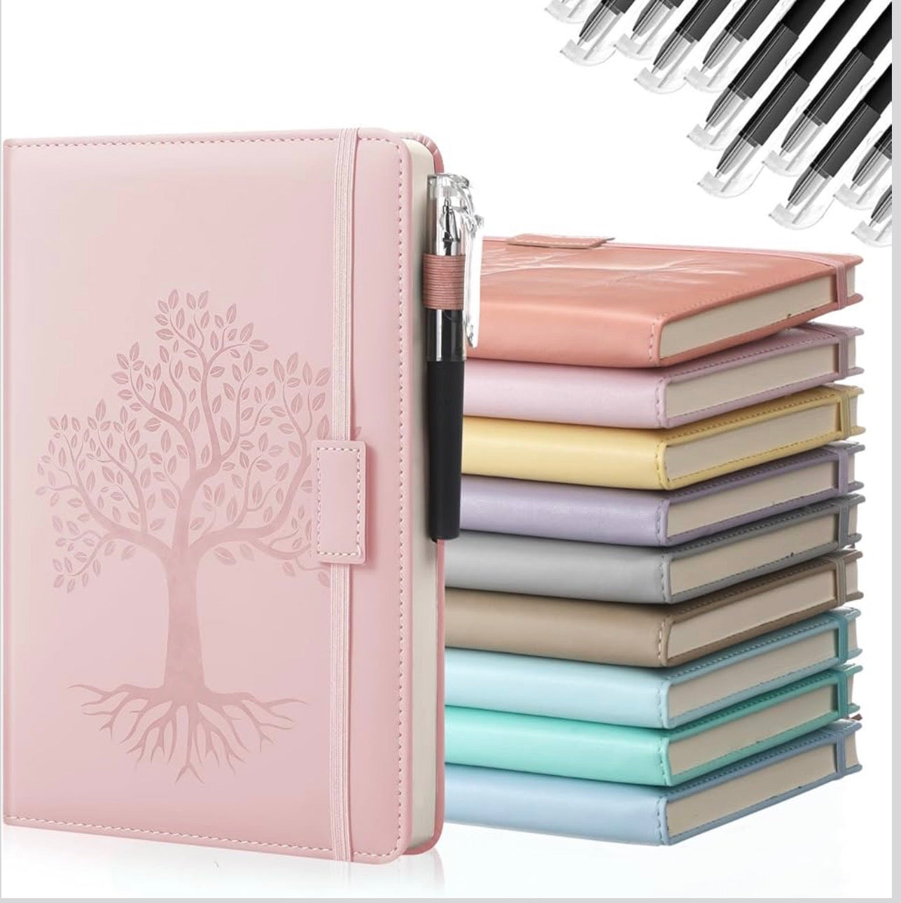 Pink notebook with embossed tree design and a stack of colorful notebooks.